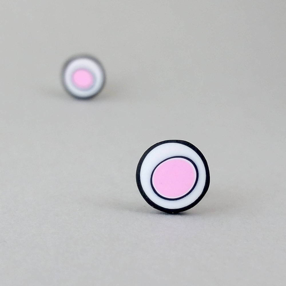 Handmade stud earrings with organic circles of pale pink on a white background with a black border.