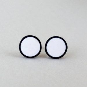 Handmade stud earrings in pure white with a black border.