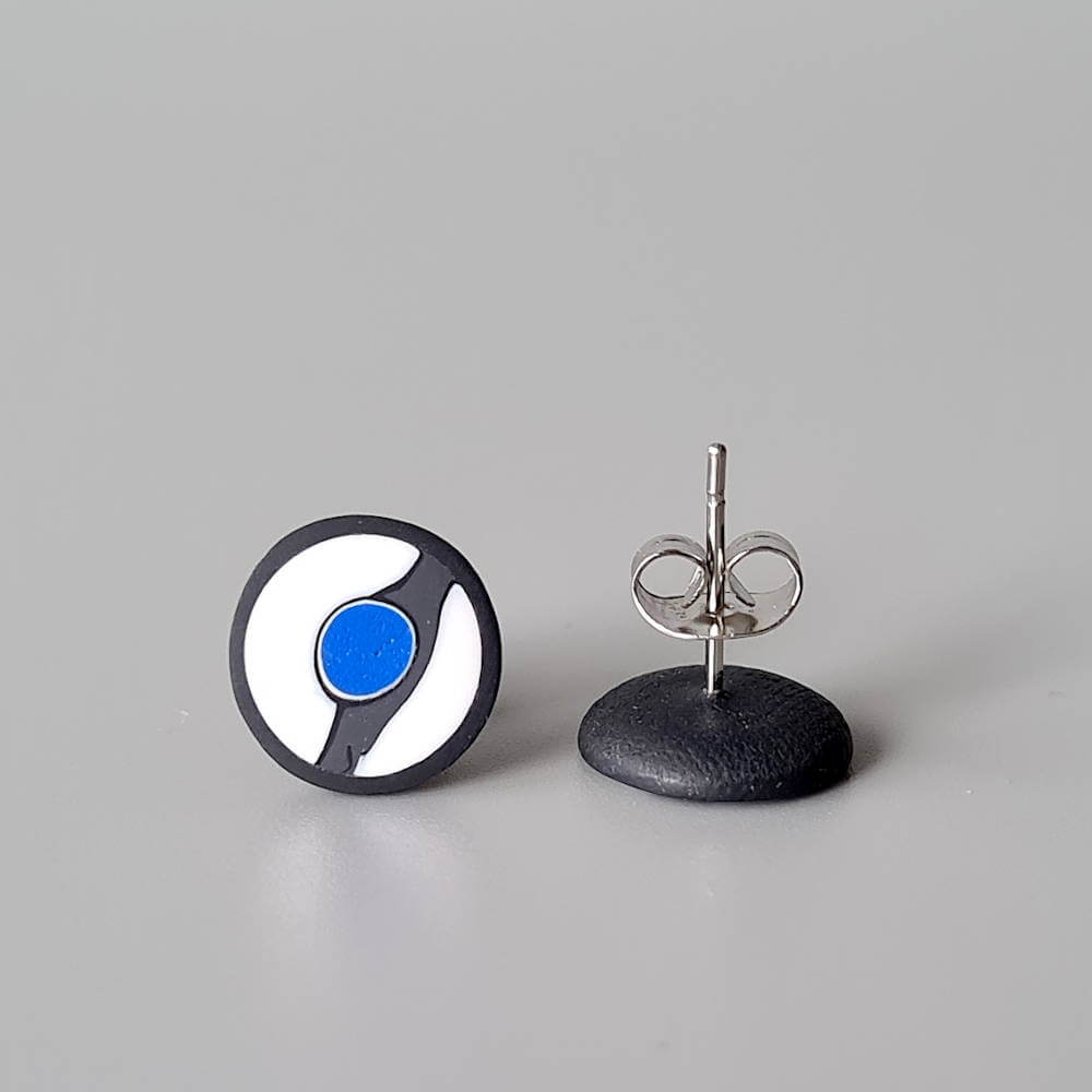 Handmade stud earrings with asymmetrical abstract flower bud pattern in blue tones, on a white background with a charcoal border. Titanium posts.